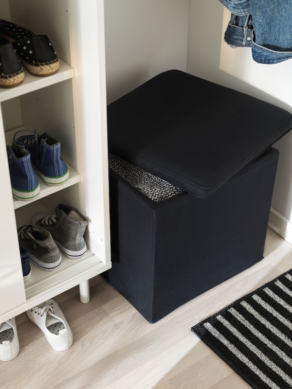 A Ransta black BOSNÄS footstool with storage in the hallway